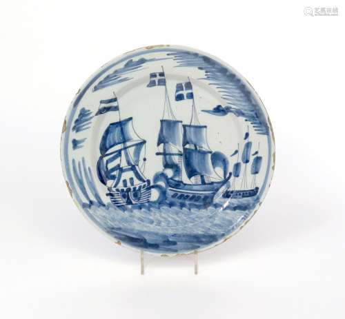 A Delft charger late 17th century, painted in blue with a sea battle, perhaps depicting a scene from