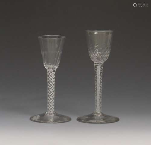 Two small wine glasses c.1760, with rounded funnel bowls, one with vertical moulded flutes, the