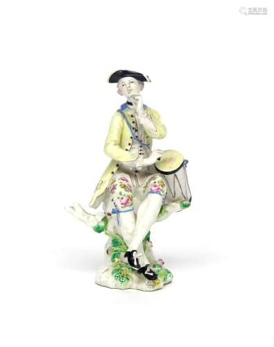 A Bow figure of a musician c.1760, seated on a tree stump and playing a fife and a drum slung over