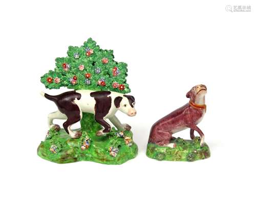Two Staffordshire pearlware figures of dogs early 19th century, one a pointer at work beneath