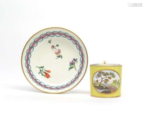 A Derby coffee can c.1815, painted with a view of a bridge in a winding valley reserved on a