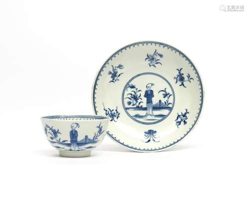 A Worcester blue and white teabowl and saucer c.1765, painted with the Waiting Chinaman pattern, the