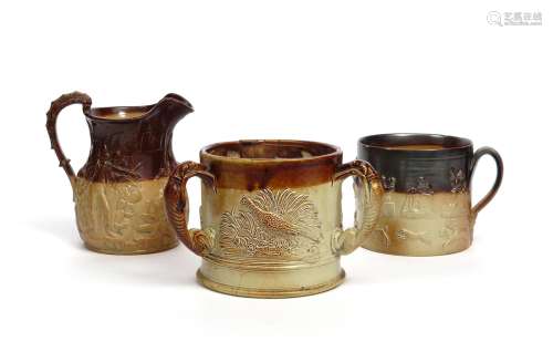 Two large brown stoneware mugs and a jug 19th century, one mug formed as a tyg with three handles