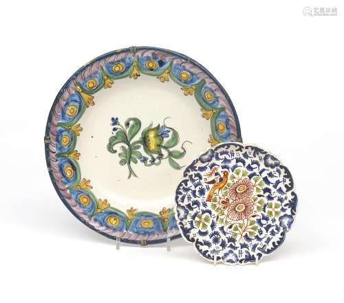 A French faïence plate 19th century, painted in polychrome enamels with a flower spray within a wide