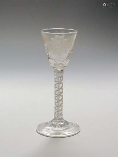 A mixed twist wine glass c.1765, the rounded funnel bowl engraved with a sunflower spray, raised