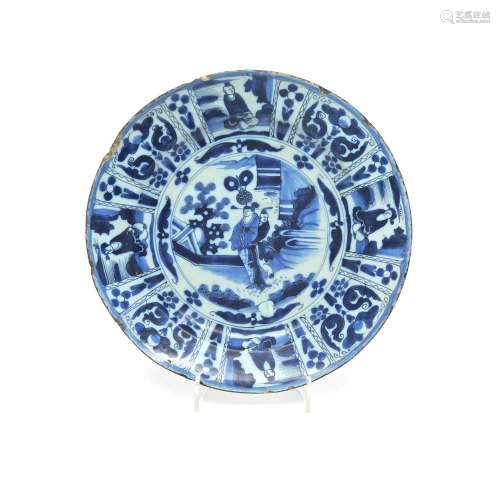 A large Delft charger c.1680, painted in the Kraak manner with two Chinese figures standing in a