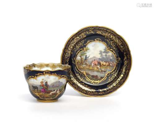 A Meissen cup and saucer 19th century, the cup painted with a scene of haymakers beside sheep and
