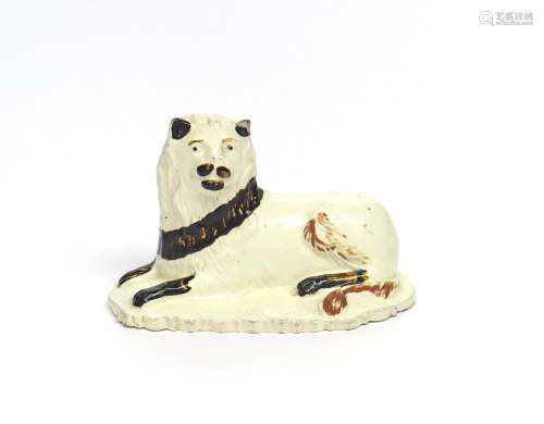 A rare Bovey Tracey creamware model of a lion c.1770-90, recumbent and with head turned to the left,