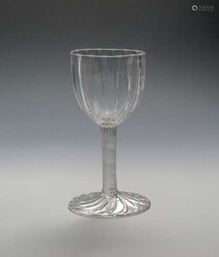A fine glass goblet c.1750, the generous rounded bowl moulded with wide ribs above an incised