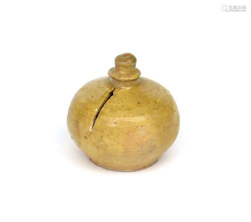A small North Devon pottery moneybox 17th/18th century, the squat globular form partially