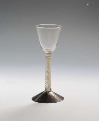 A rare canary yellow colour-twist wine glass c.1765, the rounded funnel bowl raised on a mixed