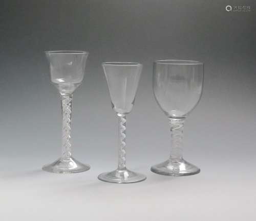Three large wine glasses 2nd half 18th century, one with an ogee bowl raised on a mixed twist
