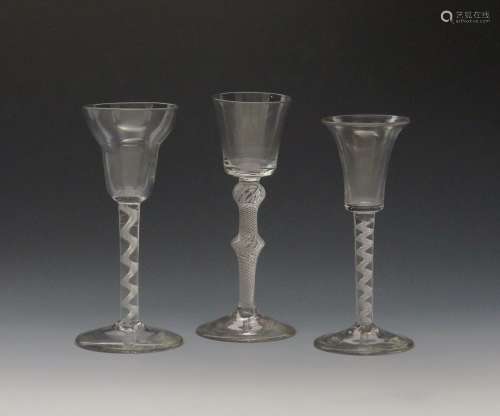 Three wine glasses c.1750-60, one with a small bucket bowl raised on a double knopped airtwist stem,
