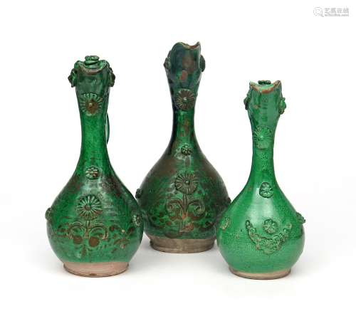 Three Canakkale (Turkey) pottery ewers 19th century, of bottle form with tall flared spouts, applied
