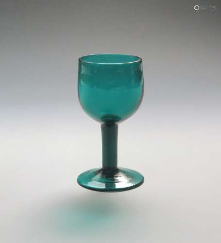 A green wine glass c.1760, with generous rounded bowl raised on a plain stem above a conical foot,