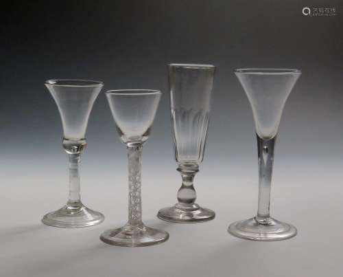 Four wine glasses c.1750-70, one with a slender bell bowl, another a drawn trumpet bowl, both raised