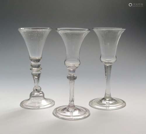 Three Continental wine glasses 1st half 18th century, one with a funnel bowl raised on a baluster