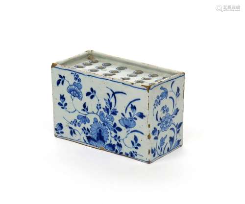 A delftware flower brick c.1760, of rectangular form, painted in blue with sprays of peony,