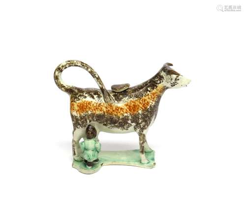 A Pratt ware cow creamer and cover early 19th century, standing four square on a flat shaped base