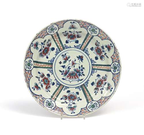 A Bristol delftware charger c.1730-40, painted in red, green and blue with six shaped panels of