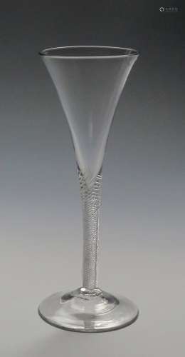 A flute wine glass c.1760-70, the slender drawn trumpet bowl rising from a dense airtwist stem above