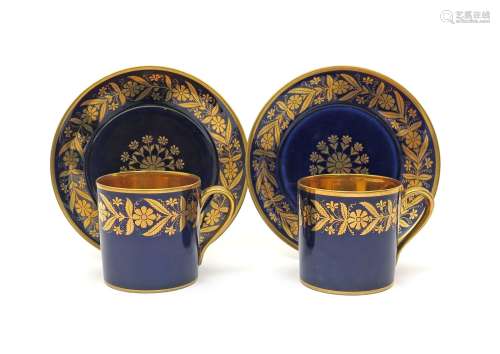 A pair of Sèvres coffee cans and saucers c.1840, decorated with a continuous formal flowerhead