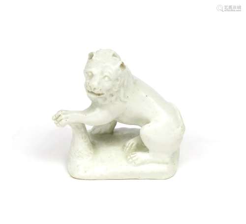 A Bow white-glazed model of a lion c.1750-52, seated on his haunches with his left forepaw resting
