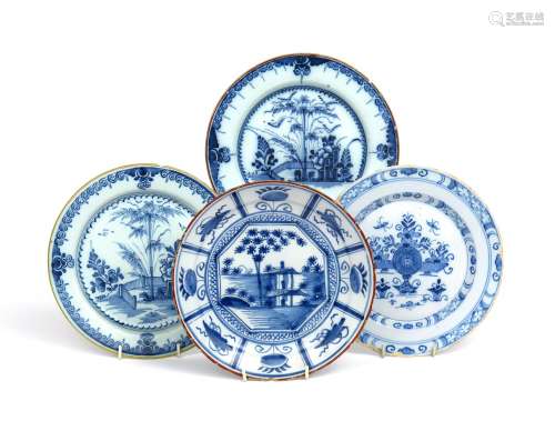 A near pair of delftware plates 2nd half 18th century, painted in blue with bamboo and other