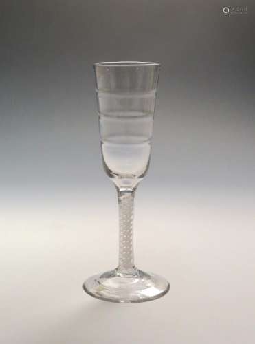 A rare Lynn ale glass c.1770, the slender rounded funnel bowl moulded with three ribs, raised on