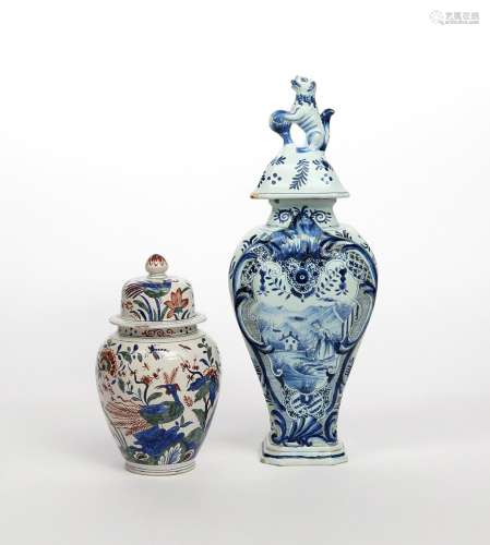 Two Delft vases and covers 18th/19th century, the larger of moulded baluster form and painted with a