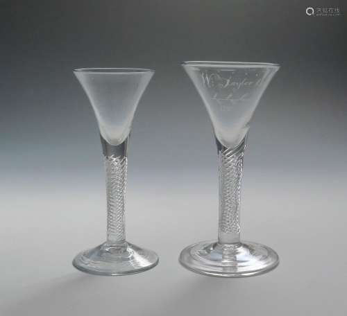 Two large wine glasses c.1760, with drawn trumpet bowls rising from thick airtwist stems above