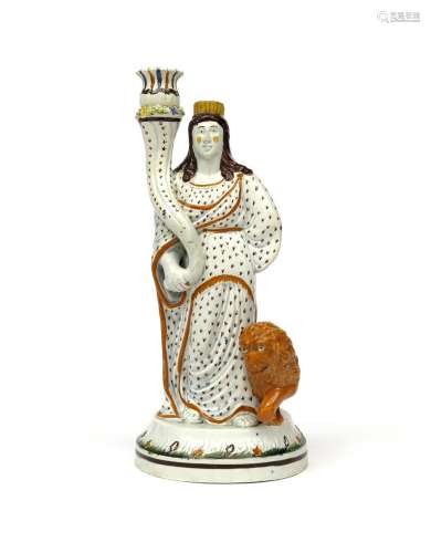 A large Pratt ware candlestick figure c.1810, modelled as the goddess Cybele, holding a long