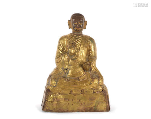 Tibet, 18th century A large repoussé gilt-copper figure of a lama