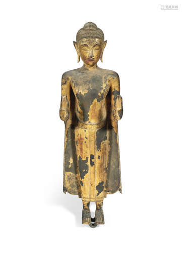 Thailand, Ayutthaya Period, circa 17th century A large standing gilt-lacquered copper-alloy figure of Buddha