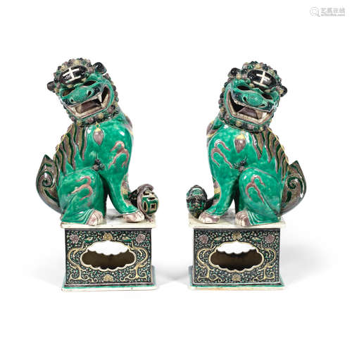 19th century A pair of large famille verte biscuit models of Buddhist lions