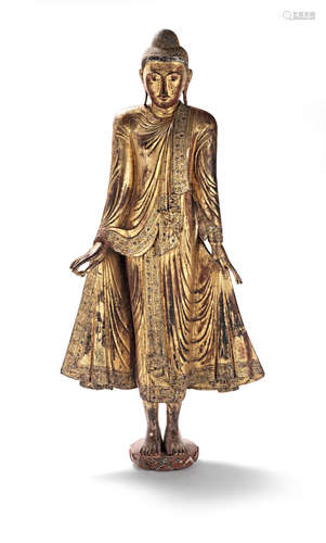 Burma, 19th/20th century A very large lacquered and gilt-wood figure of the standing Buddha