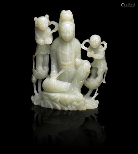 19th/20th century A large green jade carving of Guanyin and her attendants