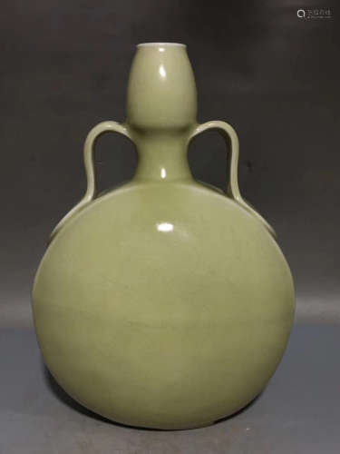 A PEA GREEN GLAZED BOTTLE