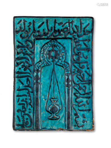 A rare underglaze-painted moulded pottery Mihrab tile Probably Kashan, dated AH 740/ AD 1339-40