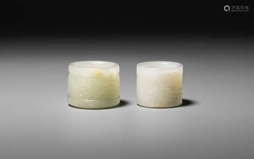 18th/19th century Two archaistic pale green jade thumb rings