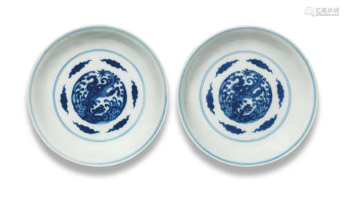 Kangxi six-character marks and of the period A pair of blue and white 'dragon and pheonix' saucer-dishes