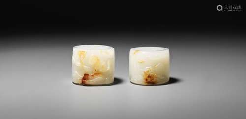 Mid-Qing Dynasty Two white and russet jade 'beasts' thumb rings