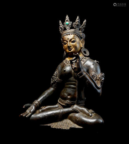 Tibet, circa 12th/13th century A very rare and large parcel-gilt bronze figure of White Tara