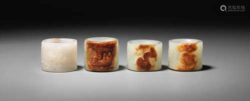 Mid-Qing Dynasty Four white and russet jade thumb rings