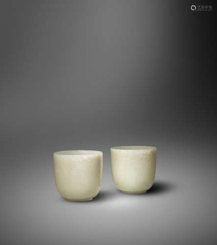 Qianlong A rare and fine pair of pale green jade wine cups