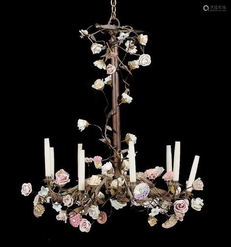 A Continental wrought metal and porcelain nine light chandelier