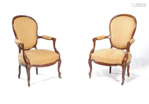 ϒ A pair of Victorian solid rosewood and upholstered armchairs