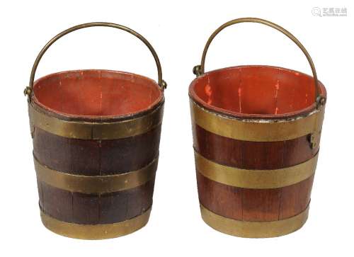 A near pair of George III gilt brass bound mahogany buckets
