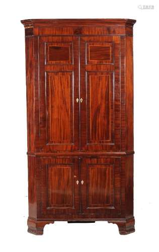 ϒ A George III mahogany and inlaid corner cupboard