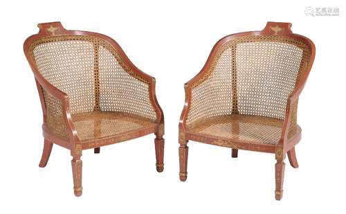 A pair of gilt and red lacquer bergere armchairs in Regency style